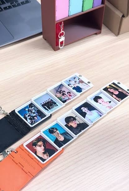 Two album keychains unfolded on a desk